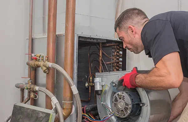 A sutton heating furnace technician performs furnace repair in Red Lodge, MT by swapping the blower motor